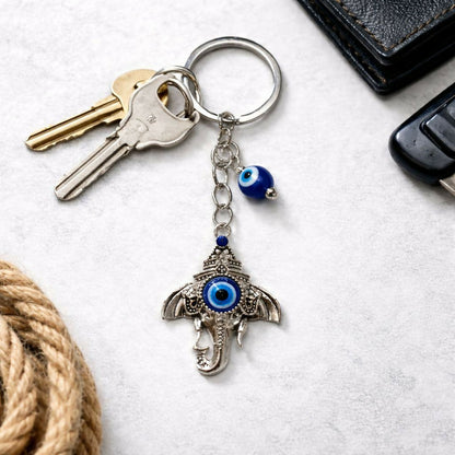 Ganesh evil eye keychain attached to bag zipper