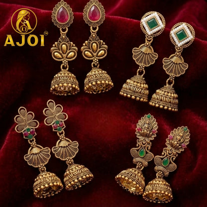 Close-up of ruby and emerald-toned stones on Temple Gold Jhumkas
