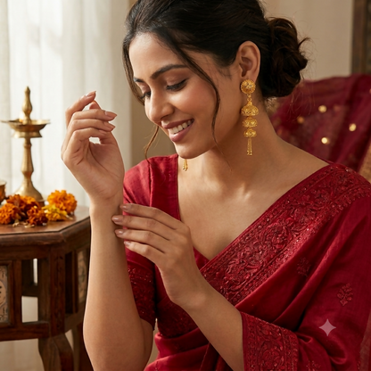 Close-up of gold-plated jhumka earrings showcasing detail