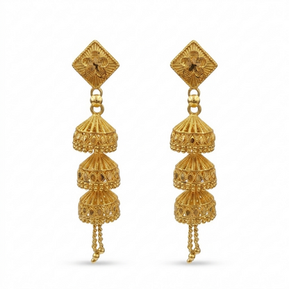 Pair of gold jhumka earrings on a clean background
