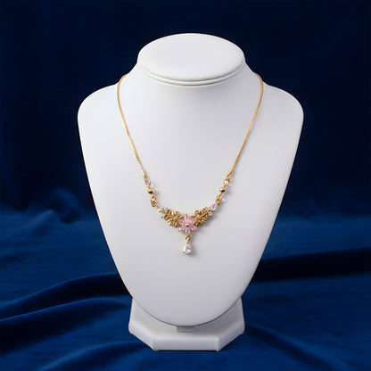 Close-up of pink floral pendant in gold finish with sparkling crystal drop necklace