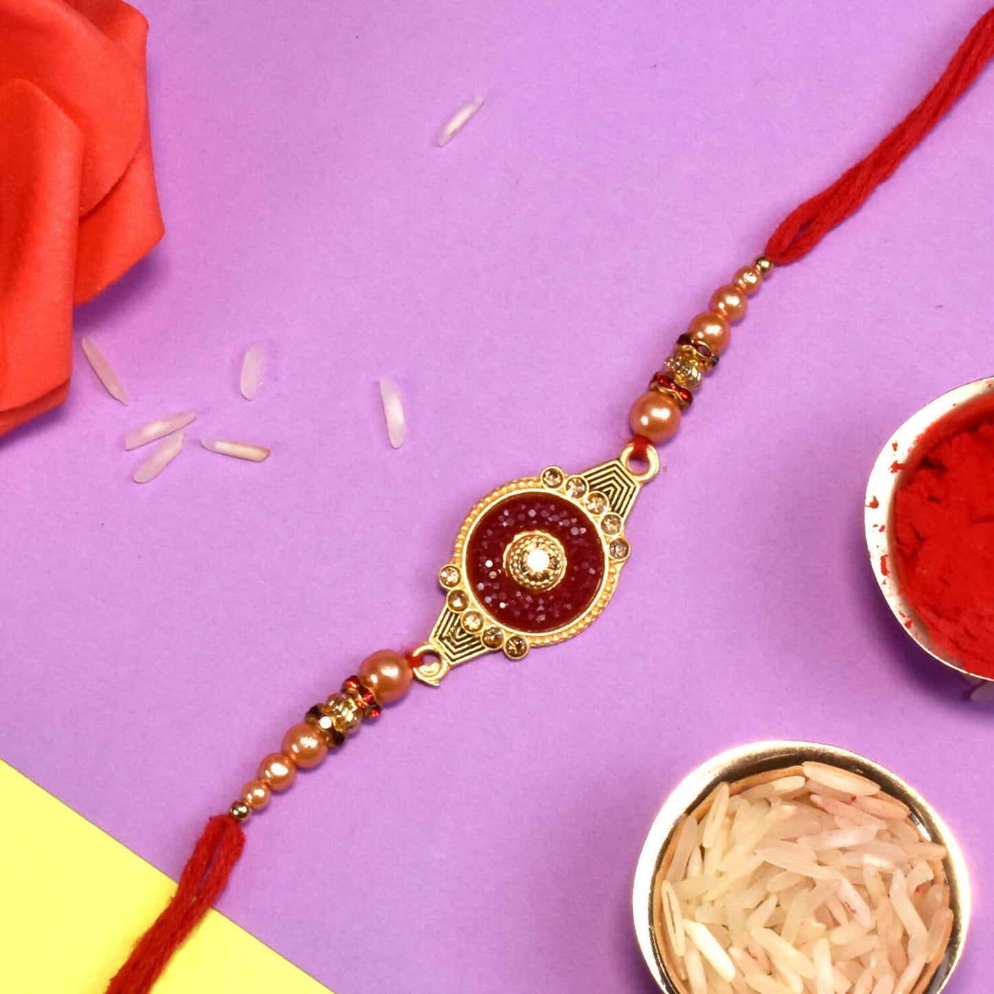 Handcrafted red kundan rakhi showcasing detailed pearl bead work