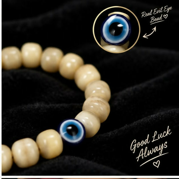 Hand wearing cream barrel bead bracelet with evil eye design