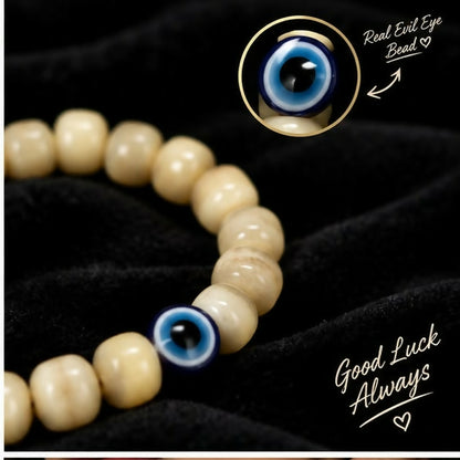 Hand wearing cream barrel bead bracelet with evil eye design