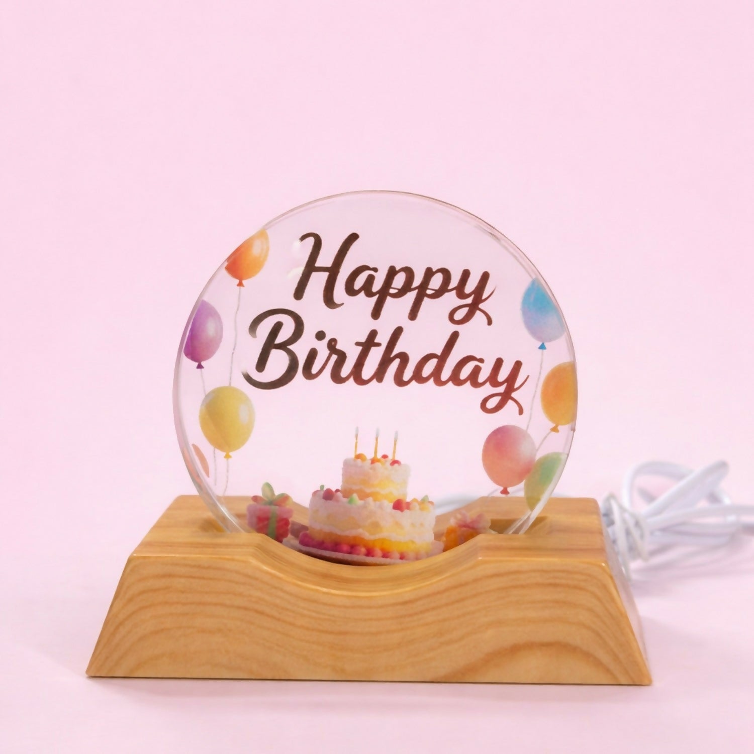 Side view of LED Happy Birthday night lamp on wooden stand