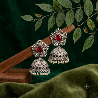 Side angle of oxidized silver jhumka earrings with pearl drops