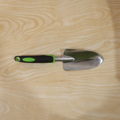 Garden tool in use for planting in flower bed