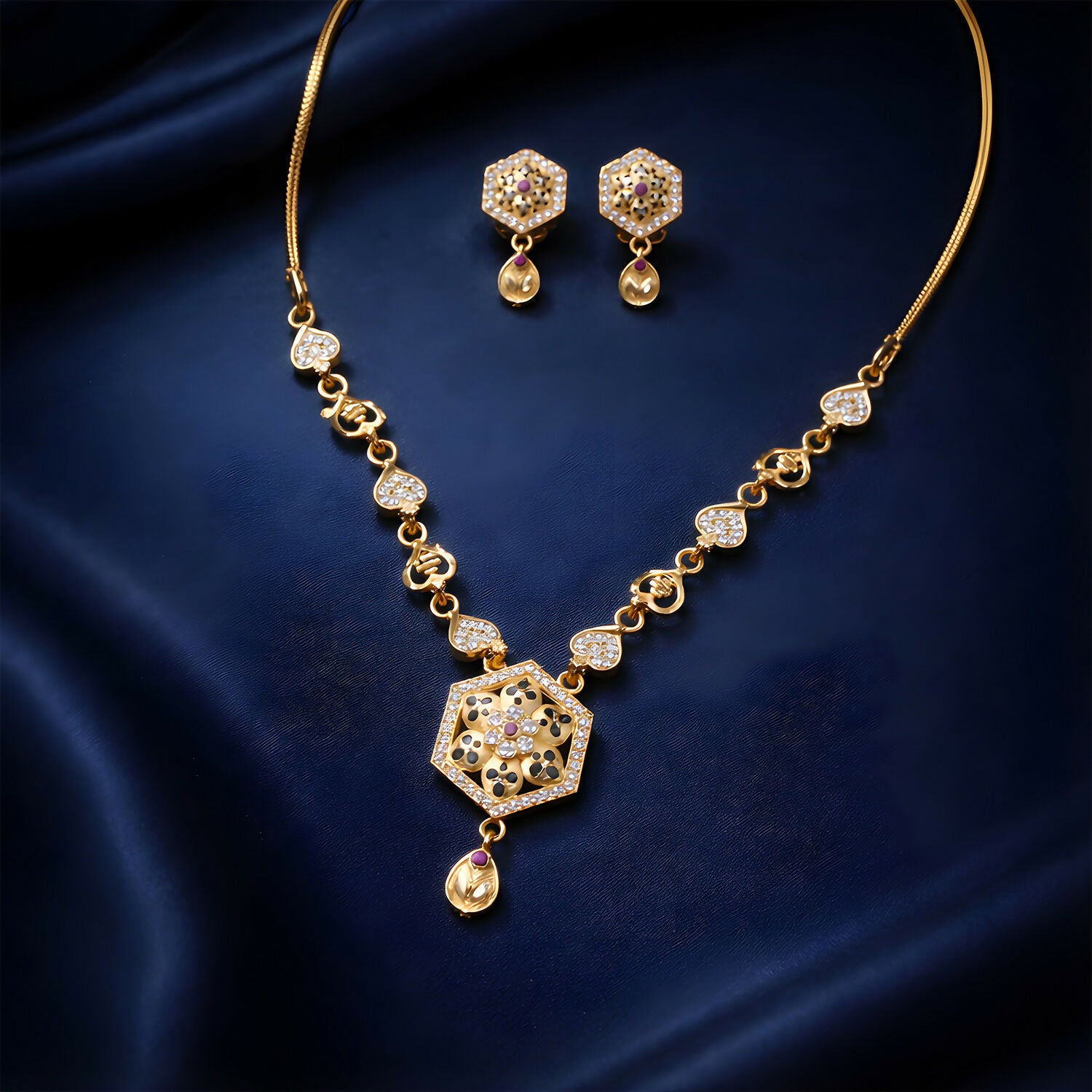 Close-up of designer gold-tone necklace set with sparkling stones