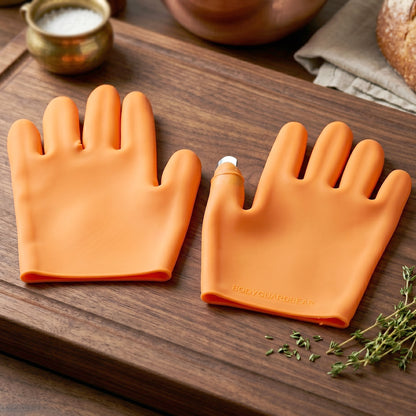Close-up of orange silicone glove material and protective thumb feature