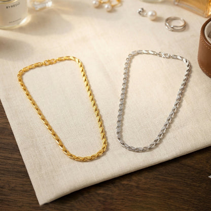 Close-up of interlocking links of dual tone chain necklace