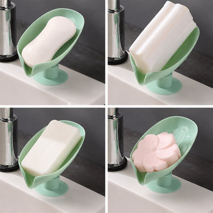 Decorative green soap holder with suction cups mounted on bathroom wall