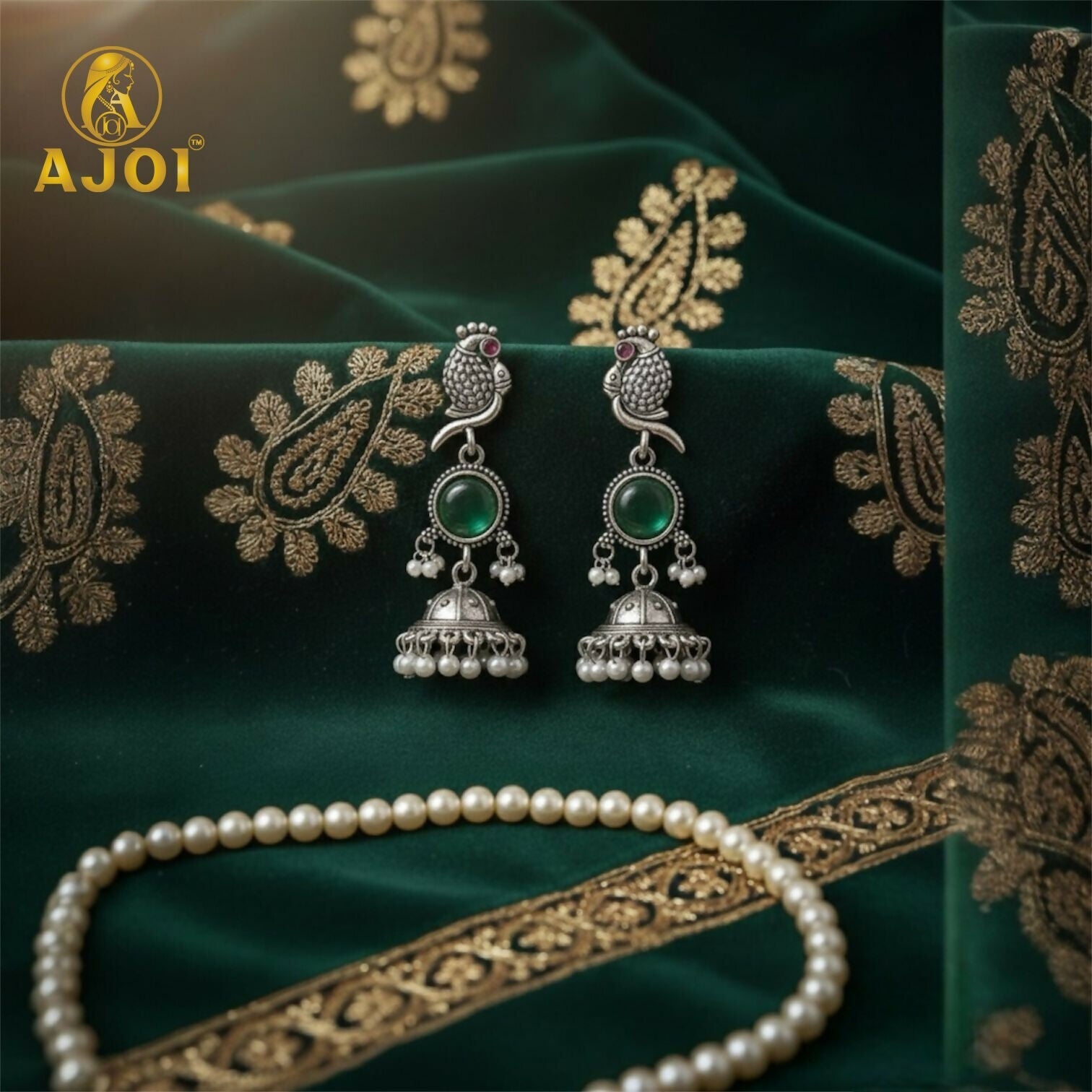 Antique silver peacock jhumka earrings with emerald stone and pearl drops - front view