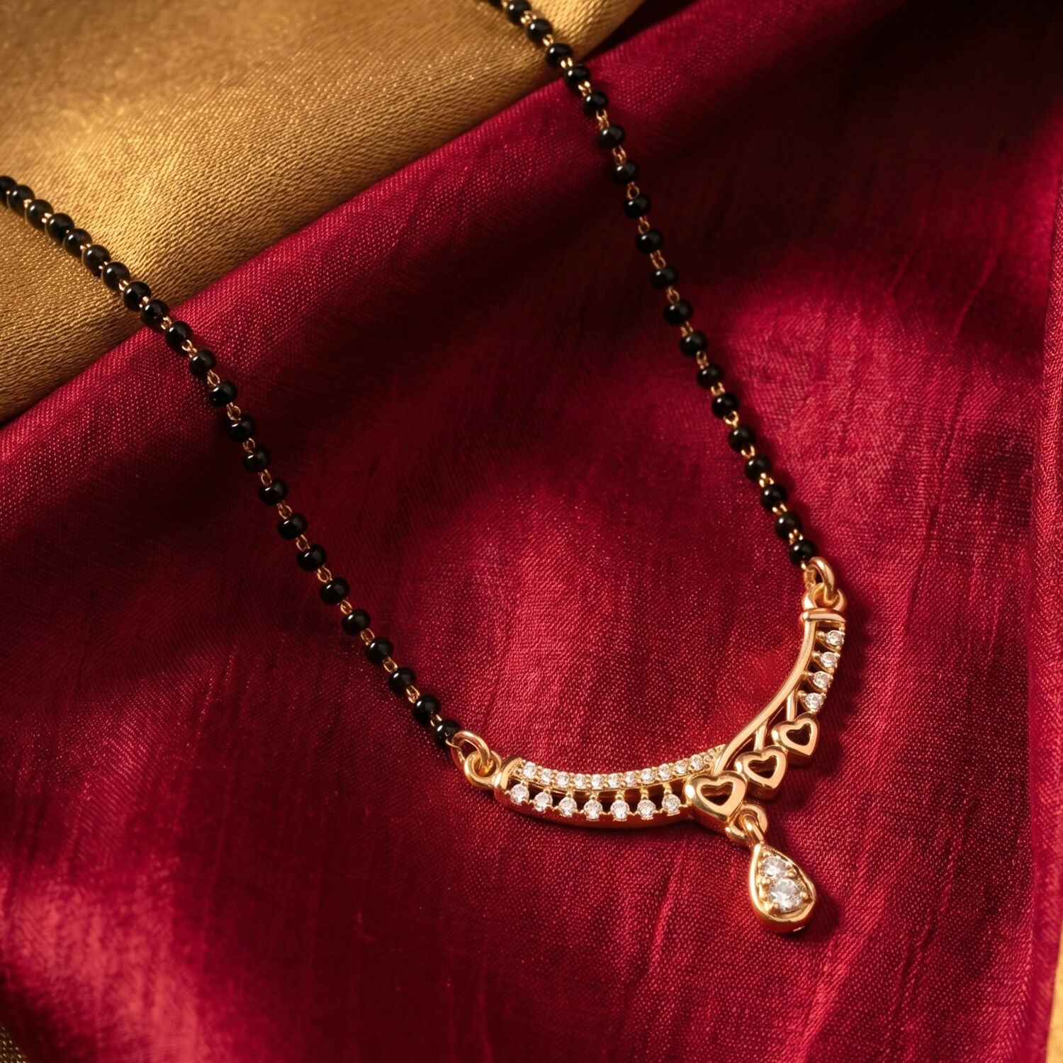 Stylish mangalsutra necklace featuring a sparkling teardrop pendant