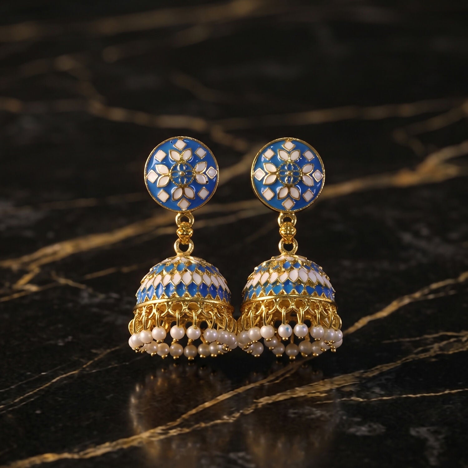 Blue stud jhumka earrings displayed on festive background