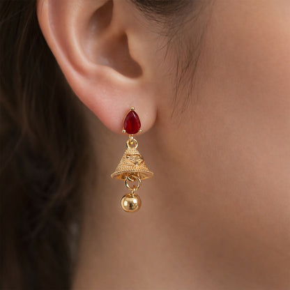 Side angle of ruby teardrop stud jhumka earrings showcasing textured gold bell