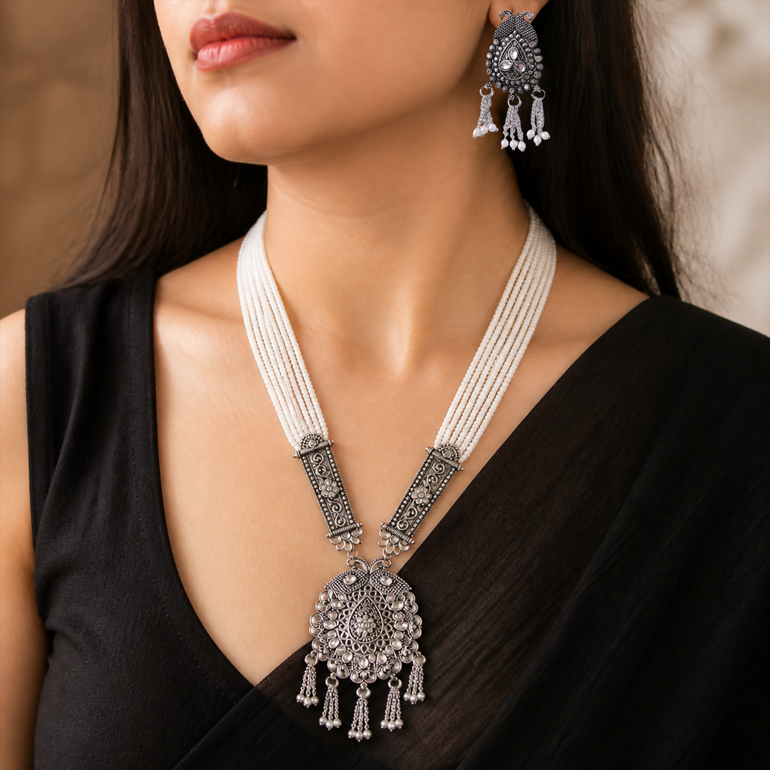 Close-up of pearl necklace and detailed pendant