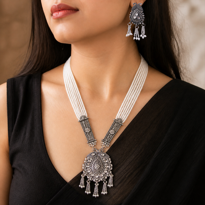 Close-up of pearl necklace and detailed pendant