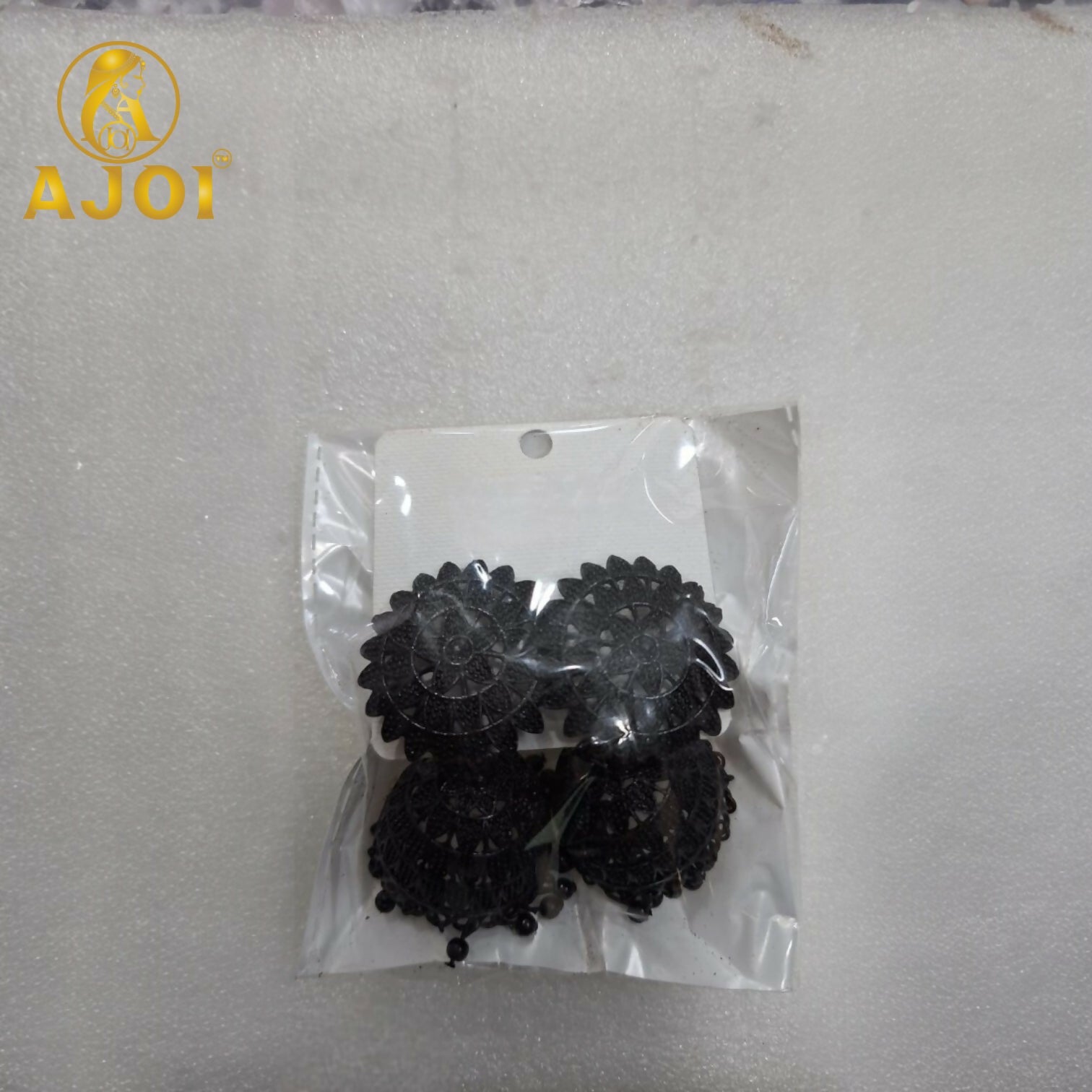 Black oxidized floral jhumka earrings showing intricate design