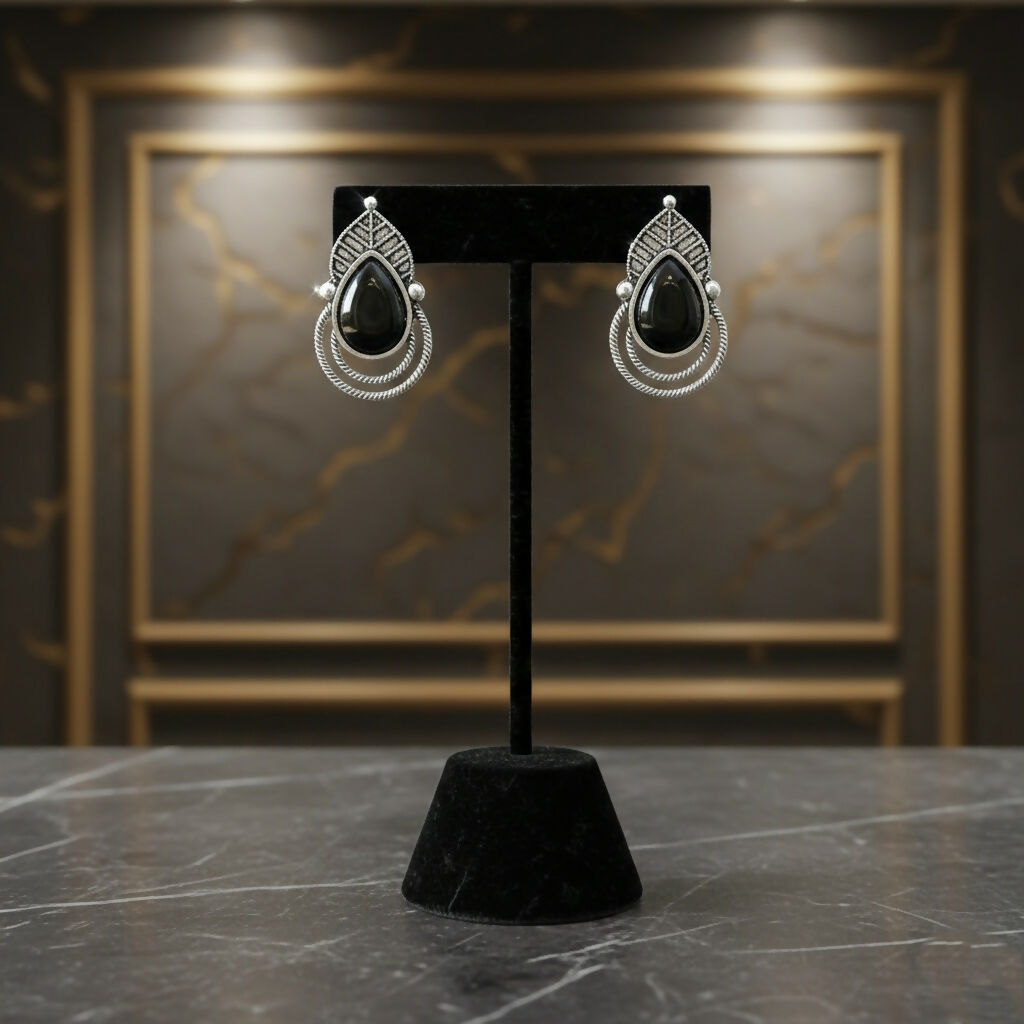 Side angle of vintage oxidized silver black teardrop earrings