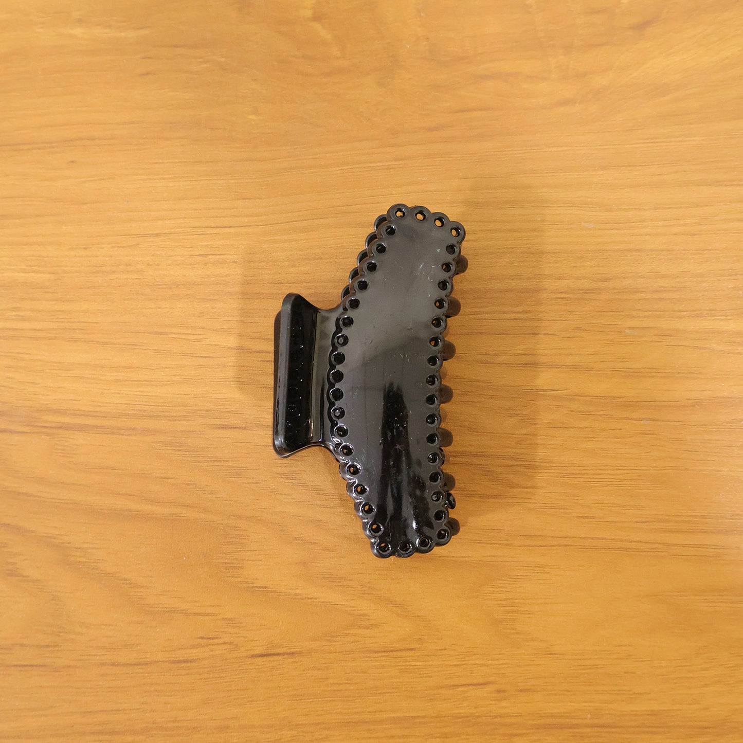 Lifestyle image showing black hair claw clip in use