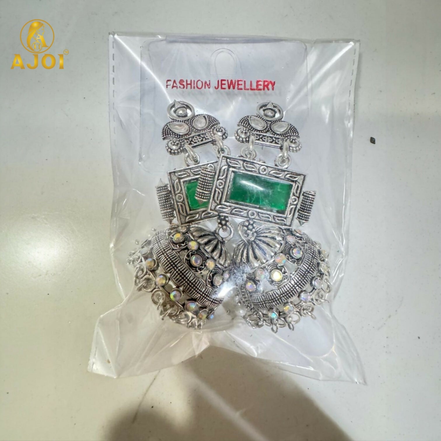 Imperial Heritage Oxidized Silver Jhumka Earrings with Deep Green Stone, Hand-Engraved Motifs, Crystal Accents & Pearl Drop Detailing.