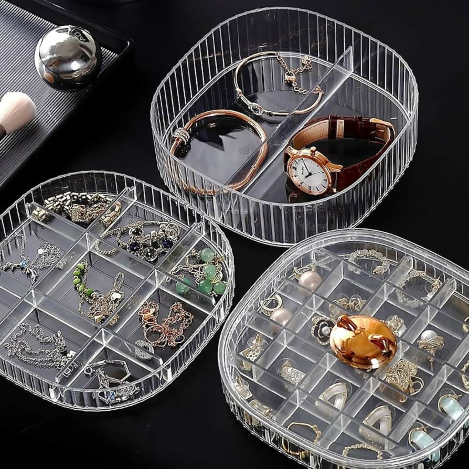 Hand rotating the transparent jewelry storage case to access different layers
