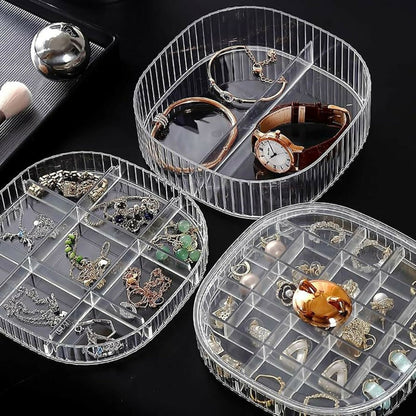 Hand rotating the transparent jewelry storage case to access different layers