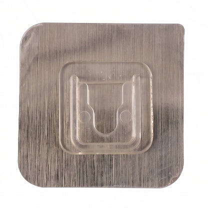 Close-up of sticky transparent wall hook installation