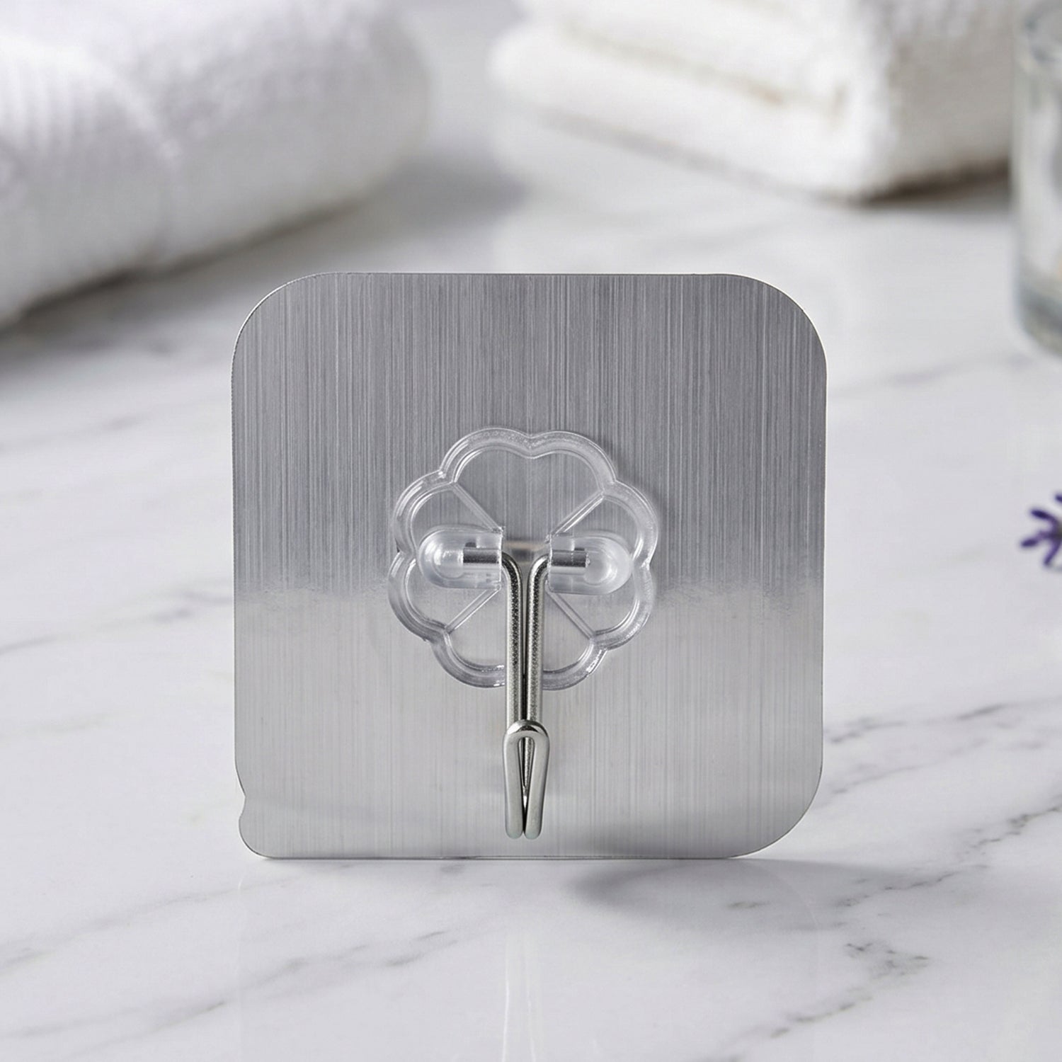 Transparent wall hook showing adhesive backing