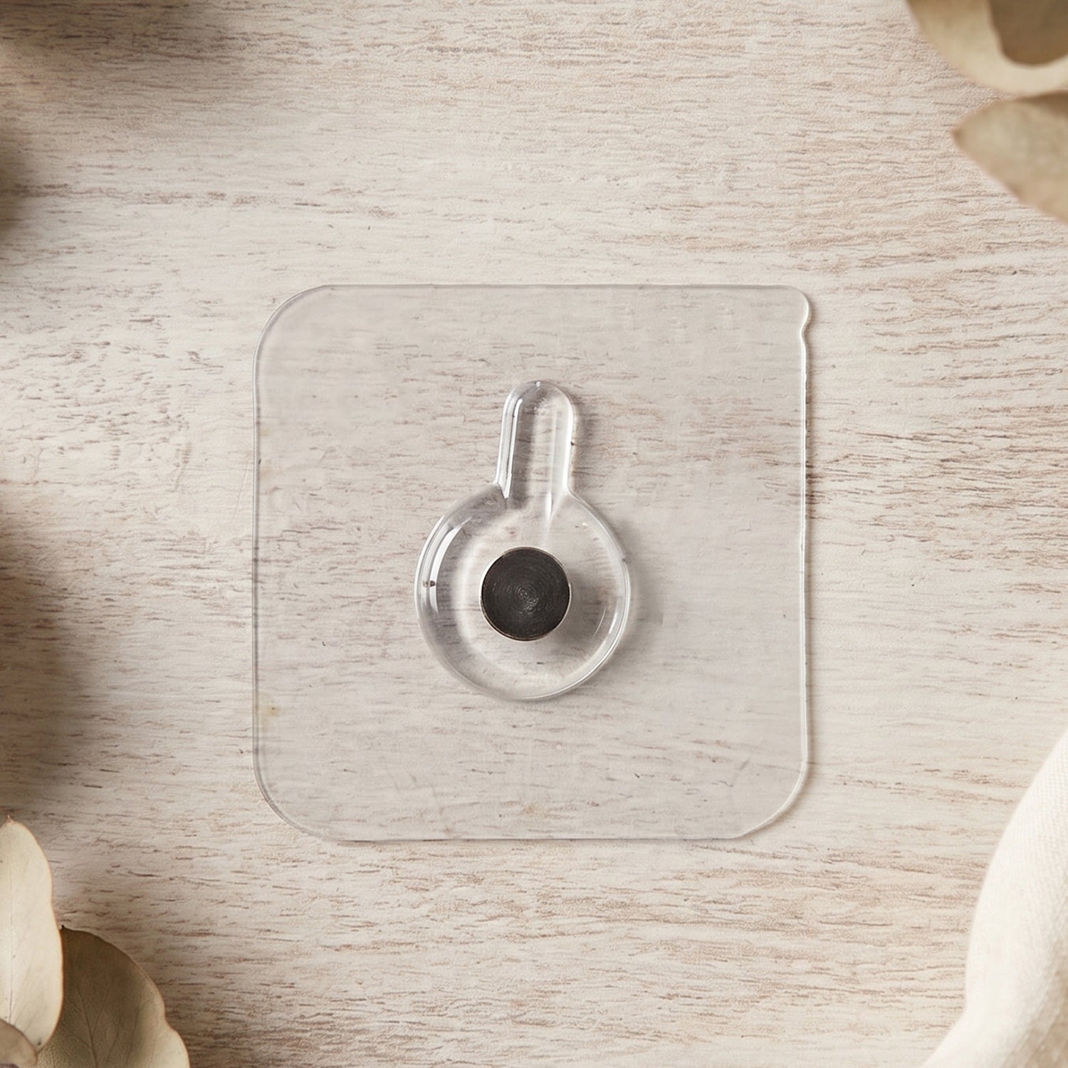 Clear adhesive wall hook on surface