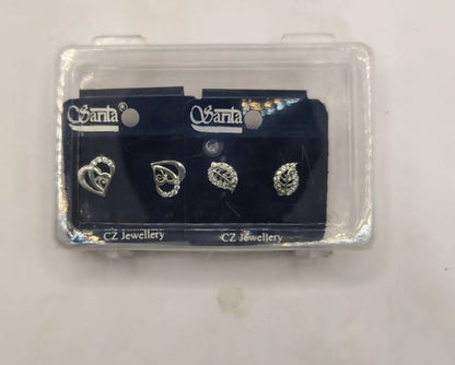Silver-plated heart and leaf stud earrings showcased on jewelry display stand