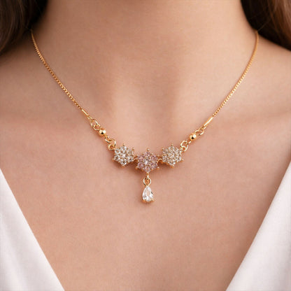 Gold finish floral stone necklace showcasing sparkling stones and teardrop pendant