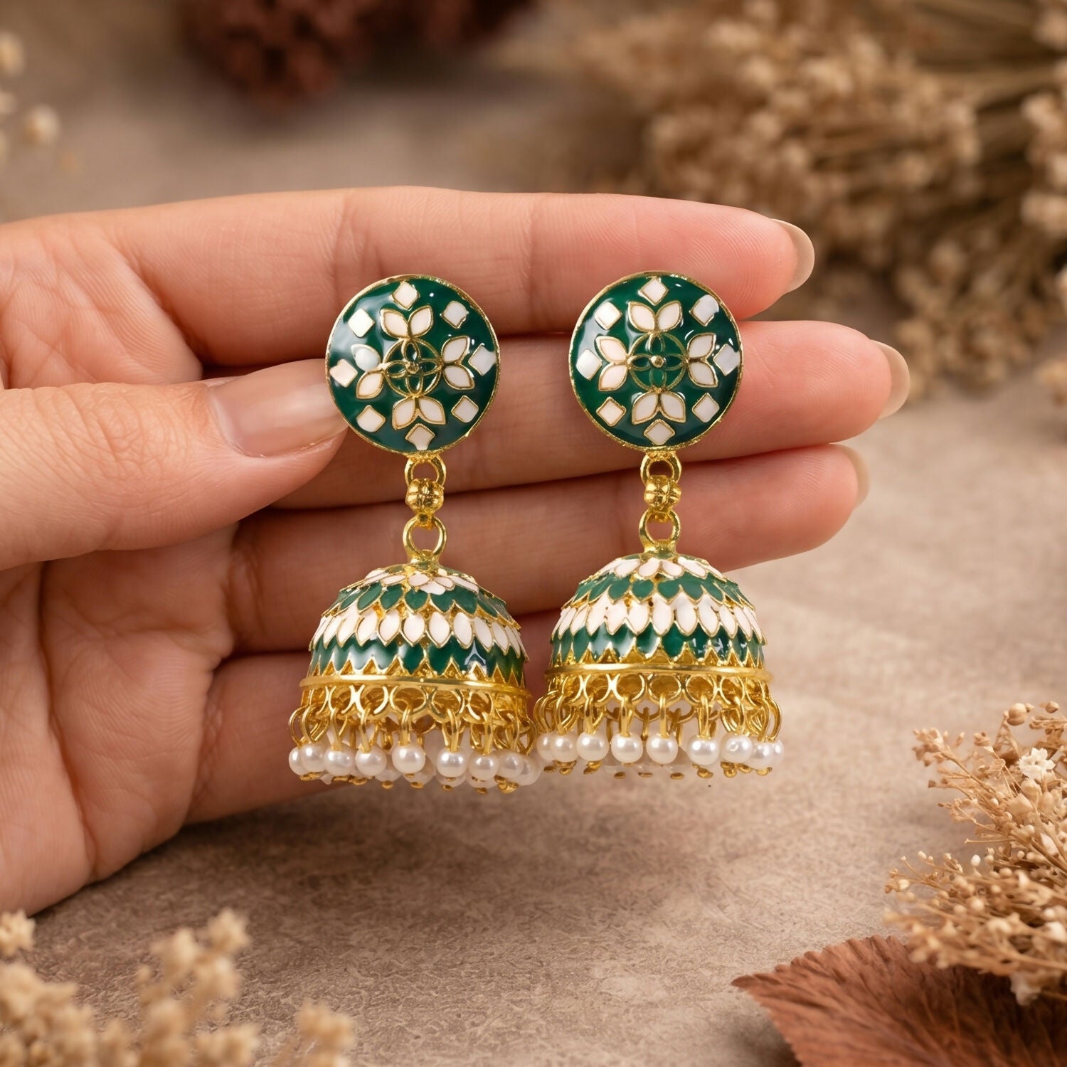 Green jhumka earrings showing intricate dome pattern