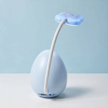 The back view of a light blue cracked egg lamp with a cloud light on a flexible arm, showing the charging port.