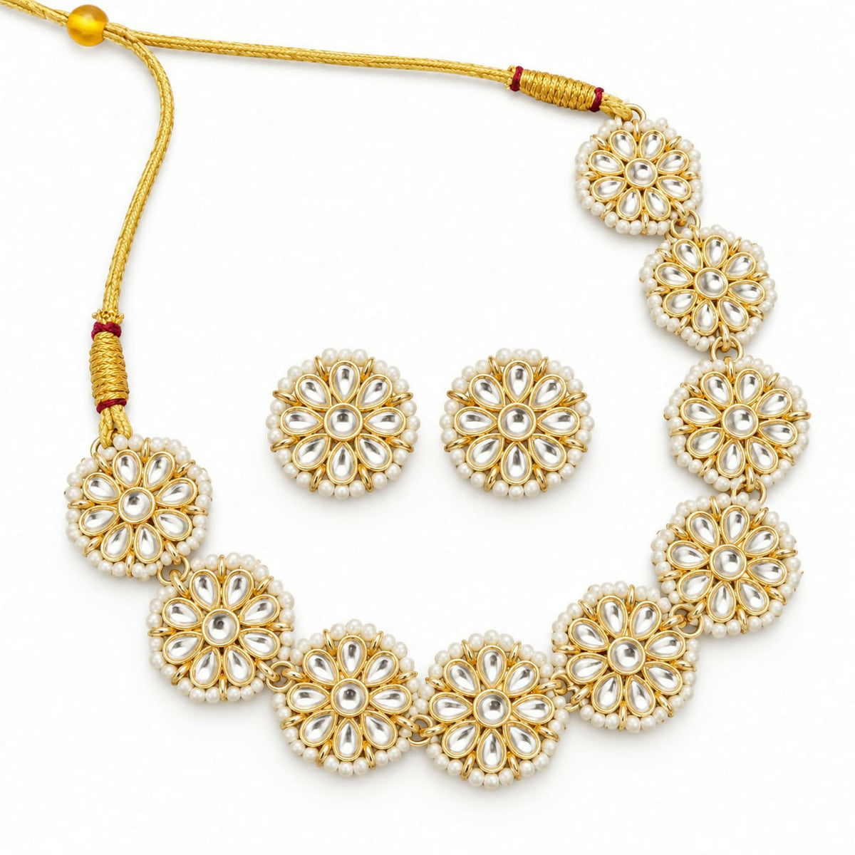 Golden kundan and pearl necklace with matching stud earrings on a plain white background.