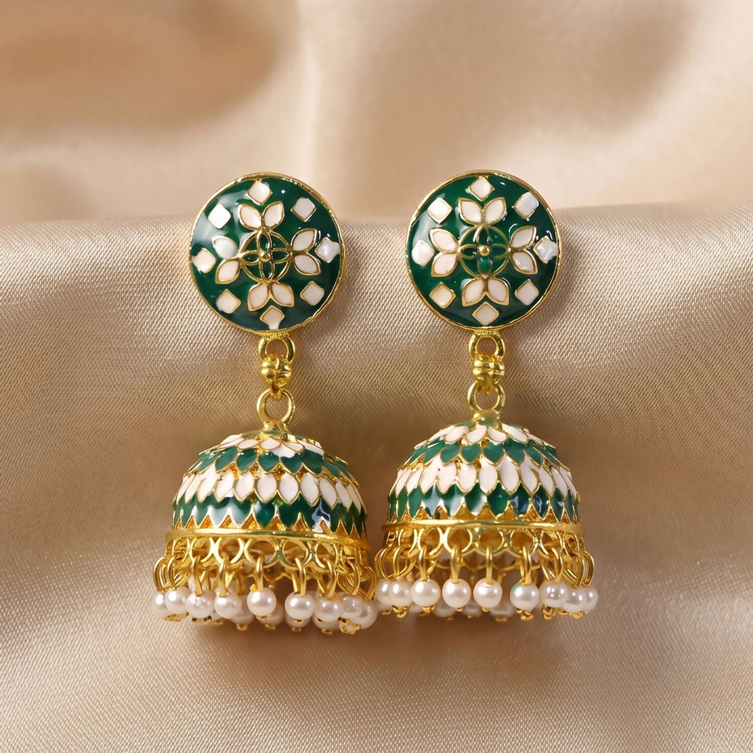 Front view of green stud jhumka earrings with pearl drops