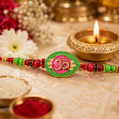 Pink green Rakhi with OM symbol centerpiece and beads