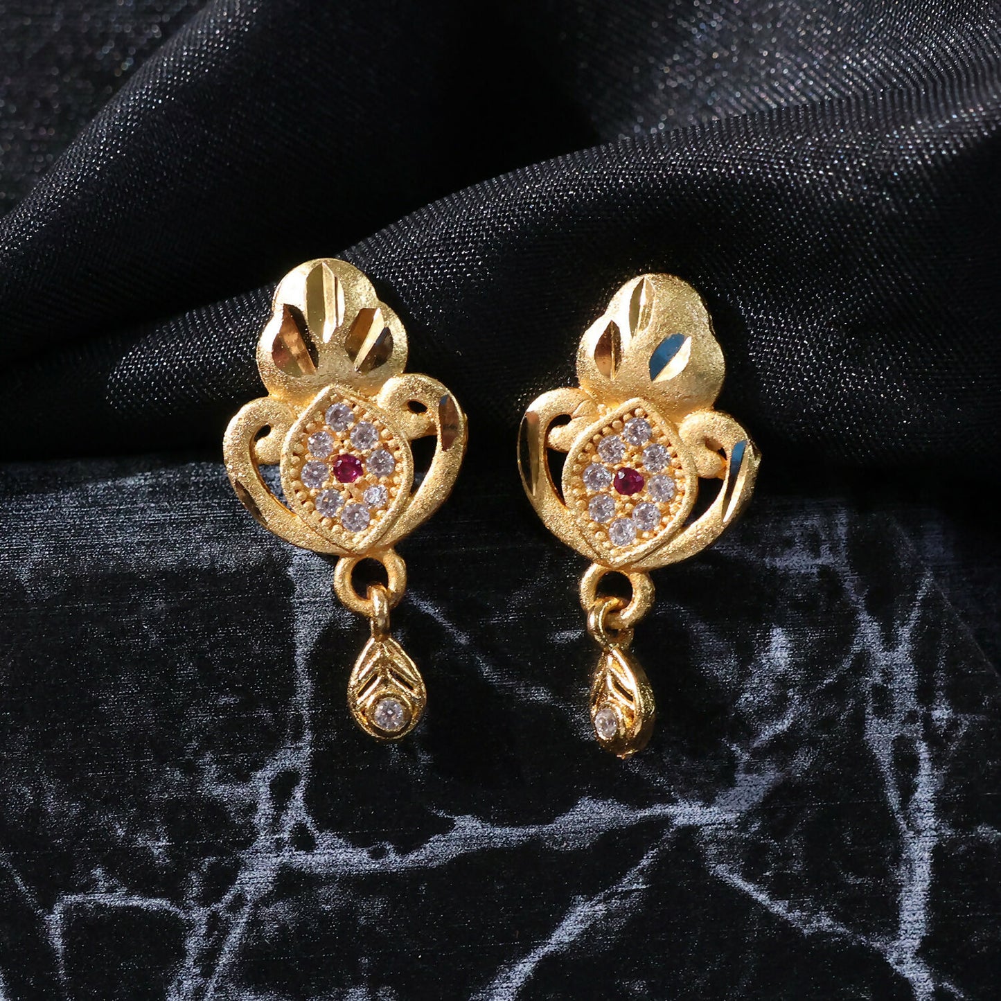 Ethnic Floral Motif Gold Stud Earrings With Stone Center And Elegant Drop Finish