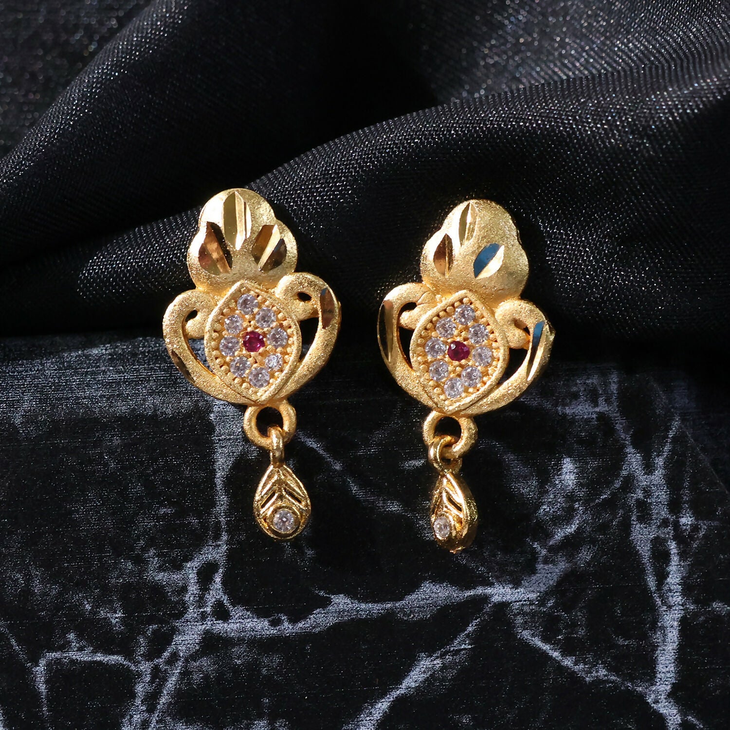 Ethnic Floral Motif Gold Stud Earrings With Stone Center And Elegant Drop Finish