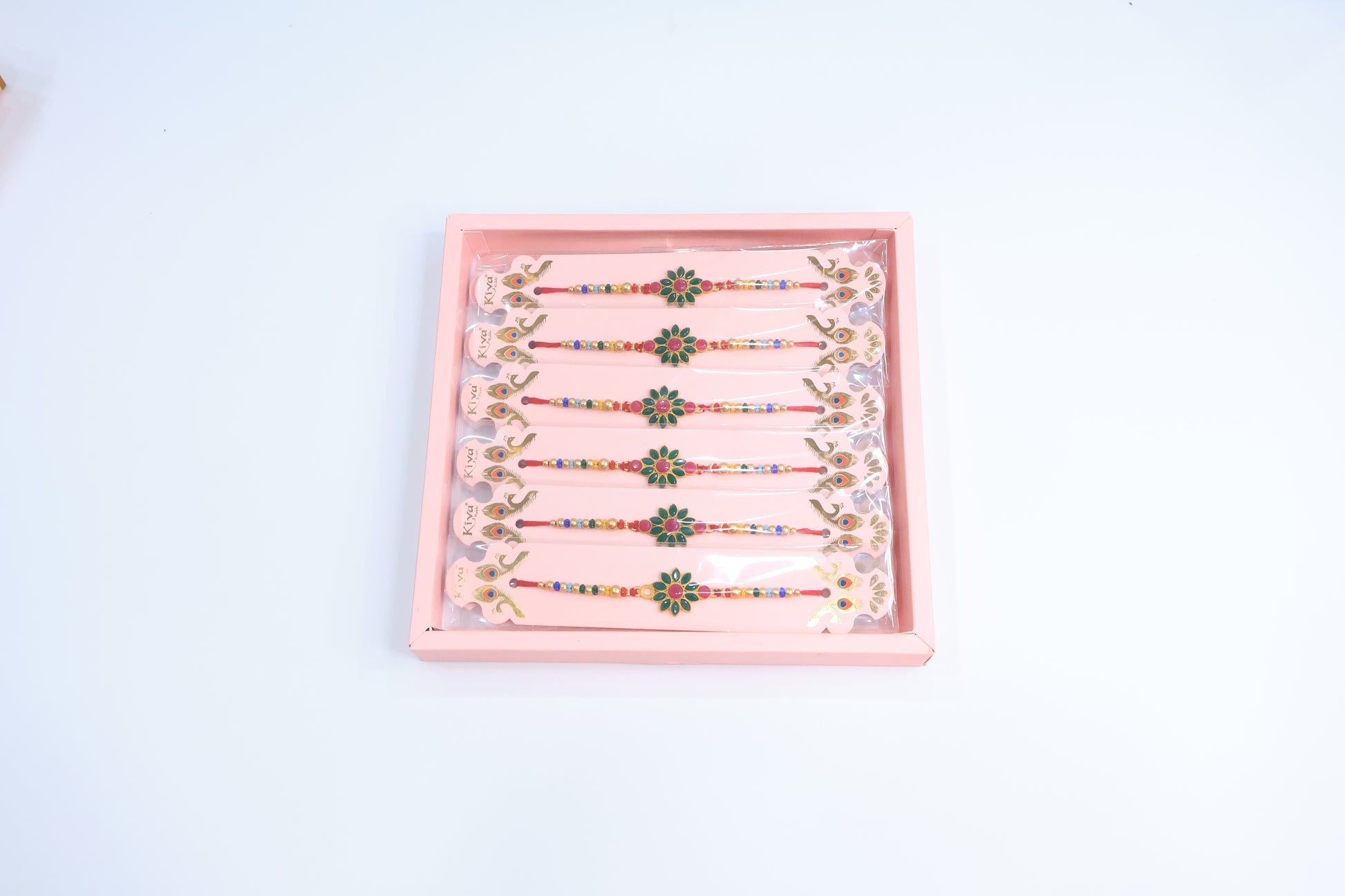 12 Pc Floral Stone Rakhi Set with Green & Pink Enamel Work and Multicolor Beads – Traditional Designer Rakhi Gift Box for Raksha Bandhan