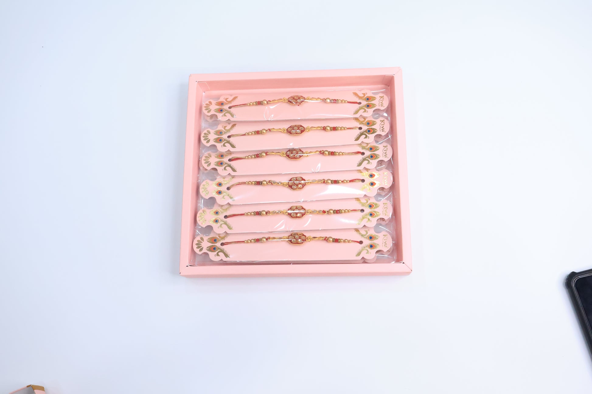 12 Pc Royal Kundan Rakhi Set with Red Enamel Work and Golden Beads – Premium Traditional Gift Box for Raksha Bandhan