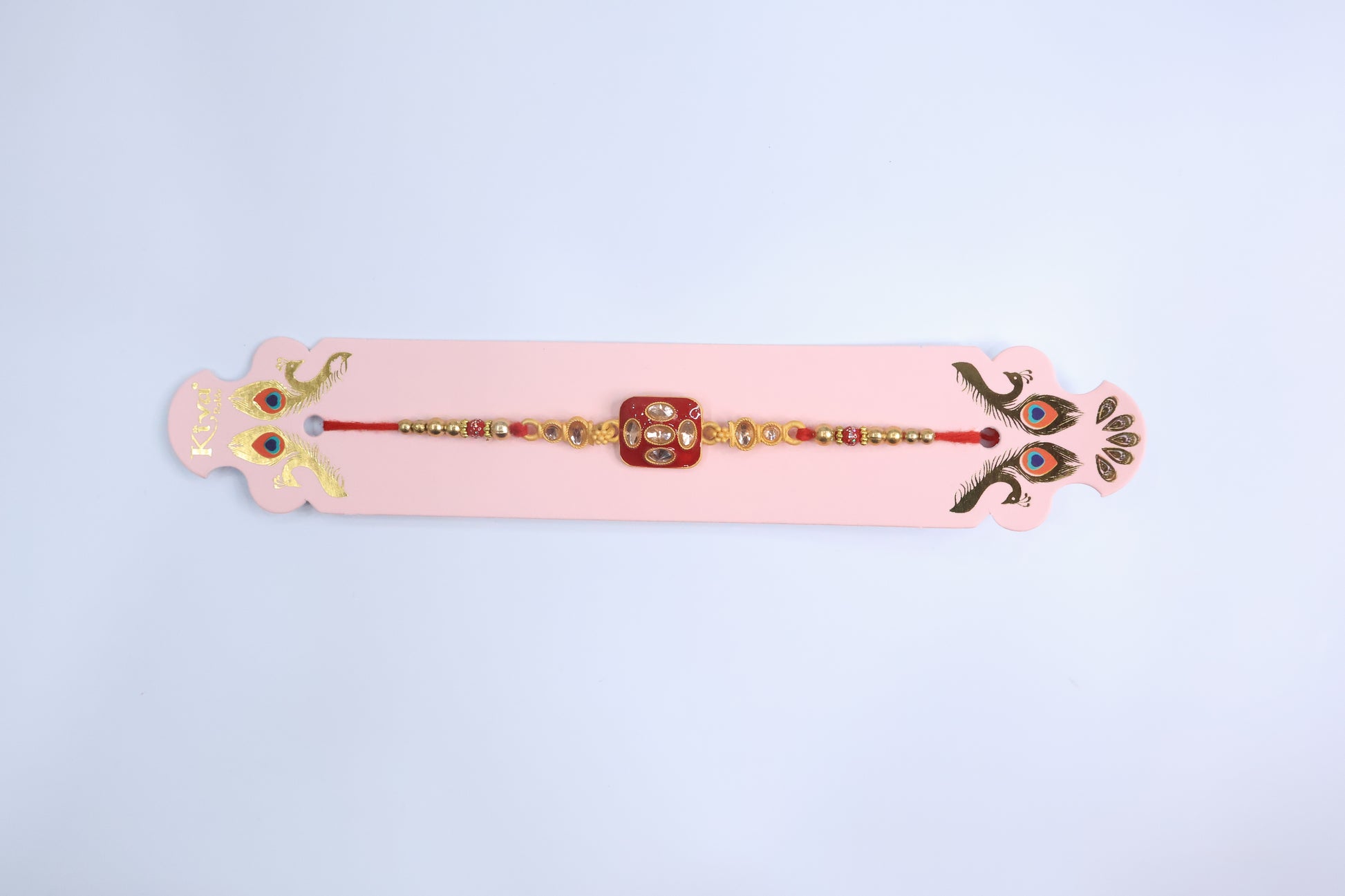 Traditional Square Kundan Rakhi with Red Enamel Dial and Golden Beads – Elegant Designer Rakhi for Raksha Bandhan