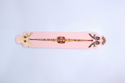Traditional Square Kundan Rakhi with Red Enamel Dial and Golden Beads – Elegant Designer Rakhi for Raksha Bandhan