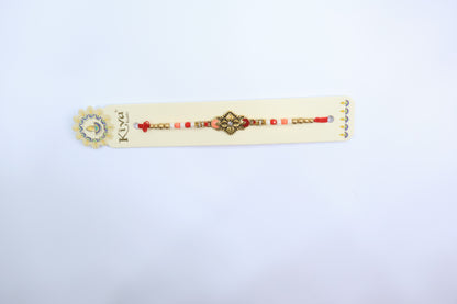 Elegant Antique Gold Rakhi with Diamond-Studded Center and Peach-White Beaded Thread