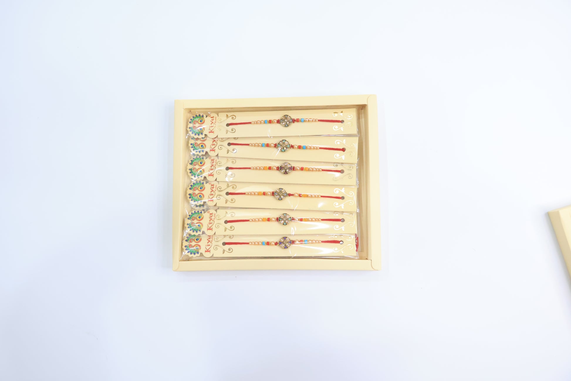 Combo Pack of 12 Antique Floral Designer Rakhis with Red-Blue Pearl Beaded Threads – Festive Gift Edition