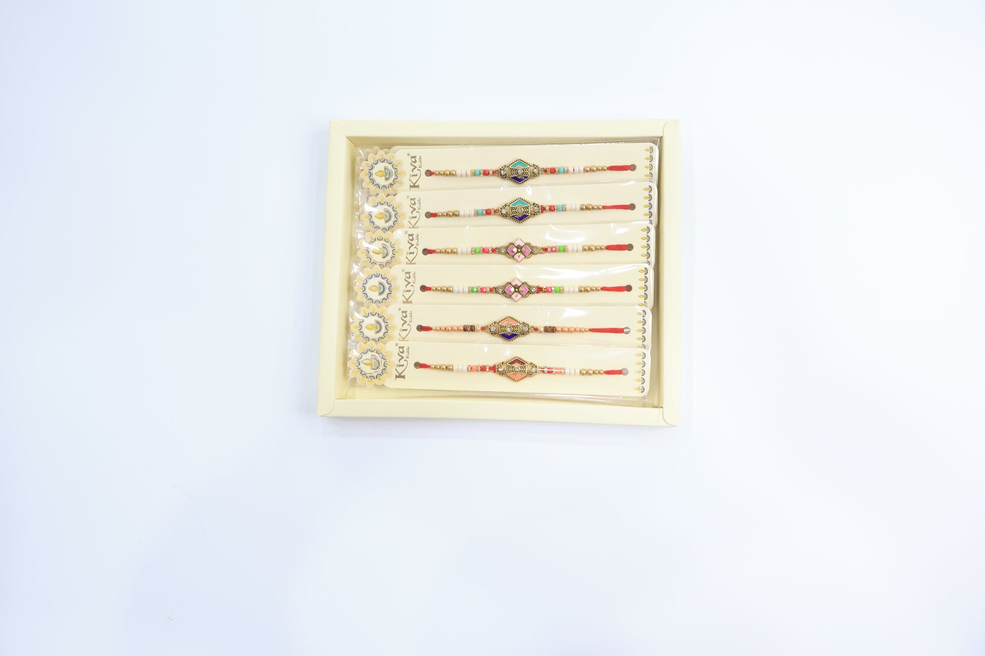 Combo Pack of 12 Geometric Designer Rakhis with Blue-Gold Dial and Multicolor Beaded Threads – Festive Gift Collection