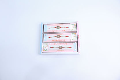 Combo Pack of 12 Designer Rakhis with Red-Green Enamel Square Motif and Pearl Beaded Thread – Premium Festive Gift Box