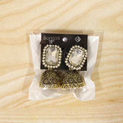Pair of white stone antique gold jhumka earrings with pearl drops displayed