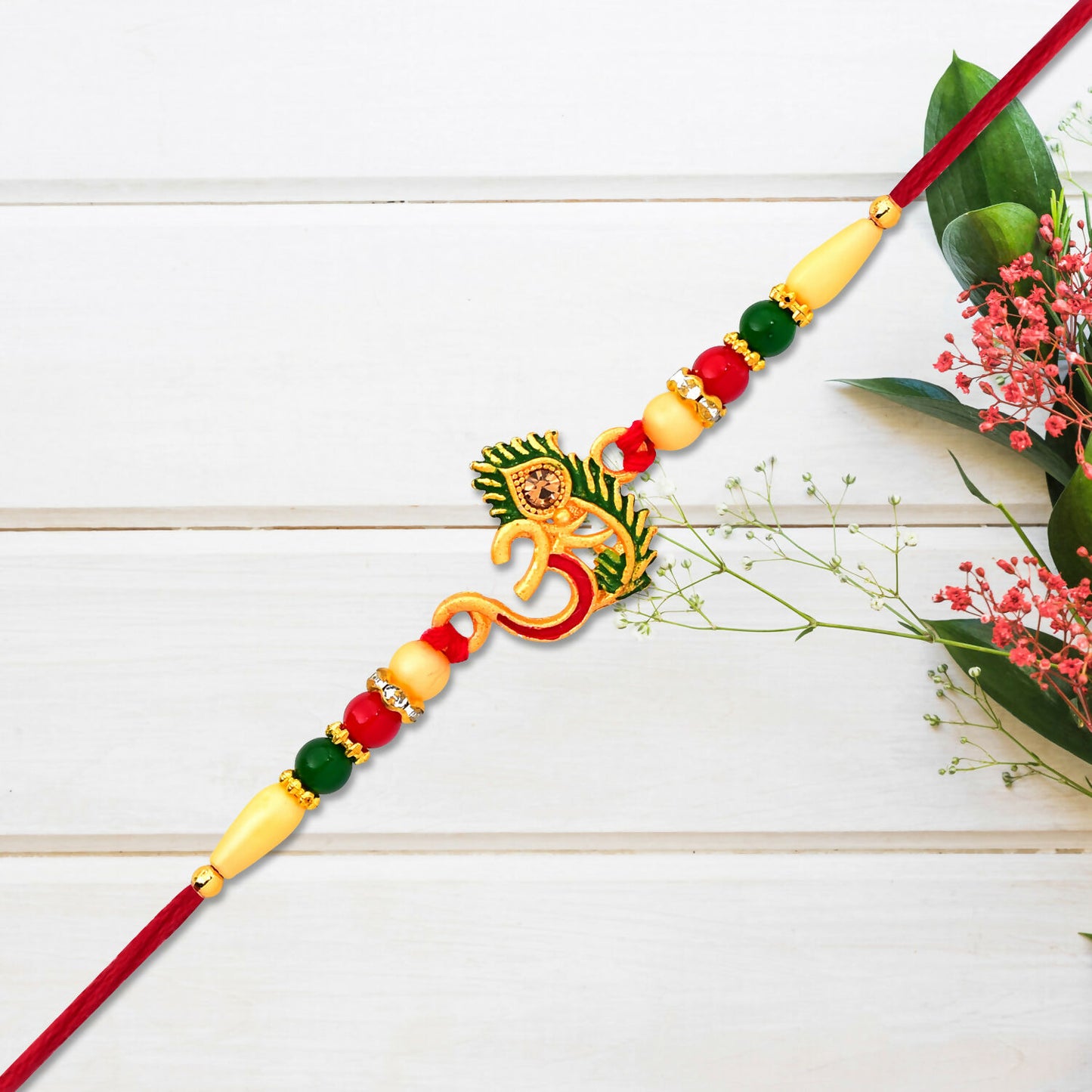Close-up of Om symbol and peacock feather on Rakhi bracelet