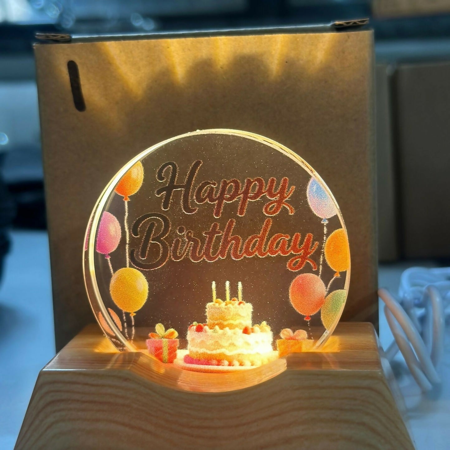 Festive LED Happy Birthday lamp showing cake and balloons design